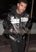 Drake Wears Supreme Hooded Satin Varsity Jacket at Madeo Restaurant