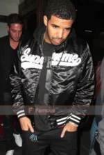 Drake Wears Supreme Hooded Satin Varsity Jacket at Madeo Restaurant